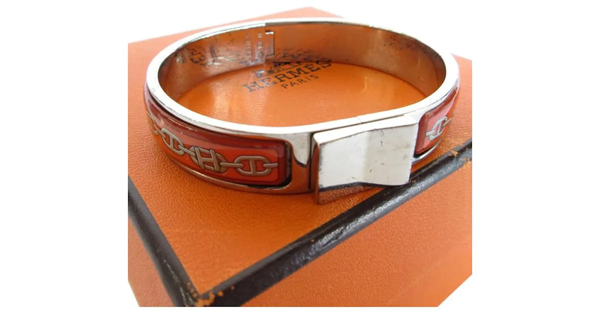 Brazalete de esmalte naranja y plata de Hermès 