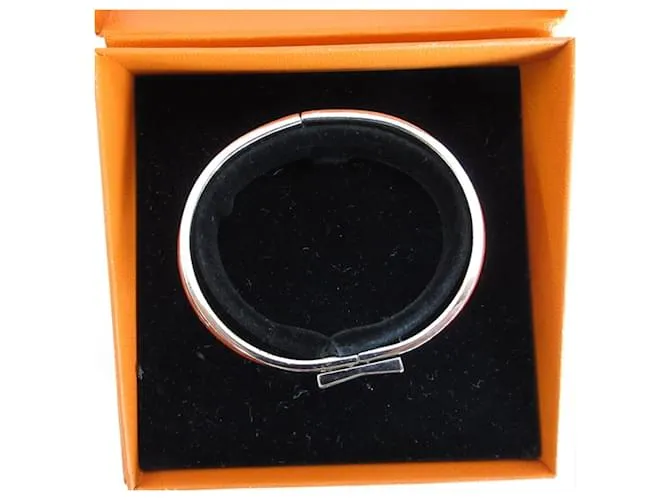 Brazalete de esmalte naranja y plata de Hermès 