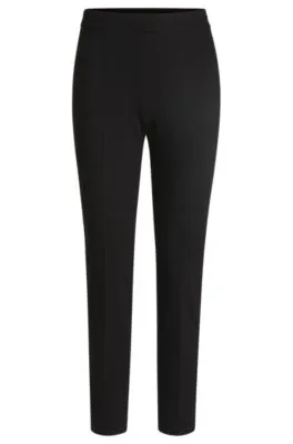 Pantalones regular fit en tejido elástico con corte cónico