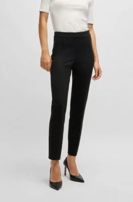 Pantalones regular fit en tejido elástico con corte cónico