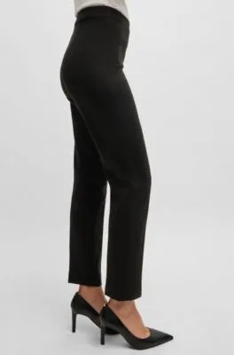 Pantalones regular fit en tejido elástico con corte cónico