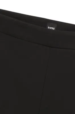 Pantalones regular fit en tejido elástico con corte cónico