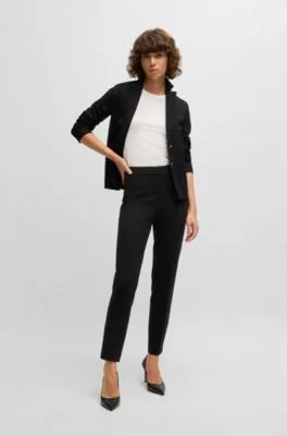 Pantalones regular fit en tejido elástico con corte cónico